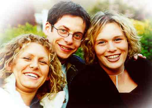 Closeup of three laughing young St Clare's students, one male, two female