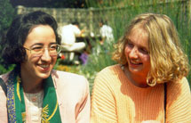 Two female students outside chatting in St.Clare's garden