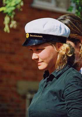 Closeup of a St Clare's student, female, young, in sailing hat, outside in sunlit garden