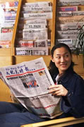 St Clare's student reading a foreign language newspaper in the Academic Resources Centre Library