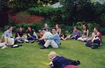 A large group of St Clare's students sitting on the grass in the garden