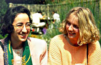 Two female students outside chatting in St.Clare's garden