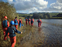 walking upstream to assess the rapid