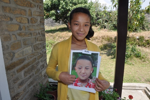 Sandhya in Nepal receiving her portrait by St. Clare's Visual Art student