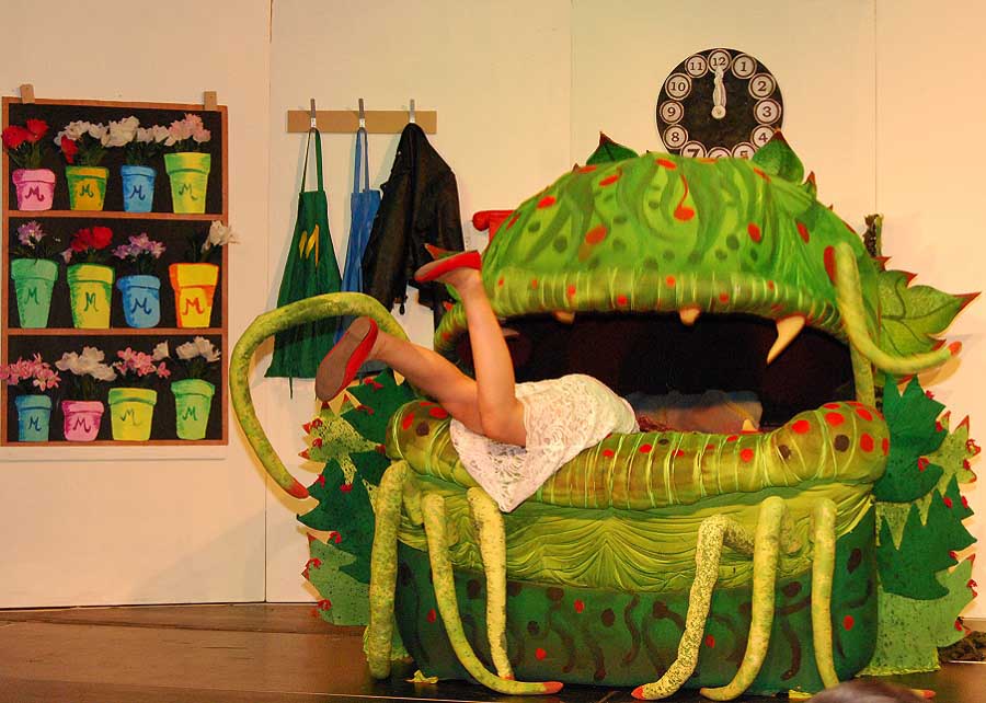 girl falling into a monster on stage