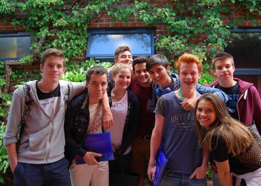 group of teenagers girls and boys in summer sunshine