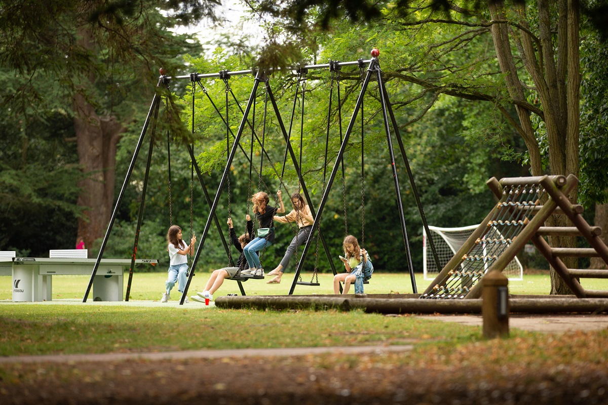 group of teenagers girls and boys in summer sunshine