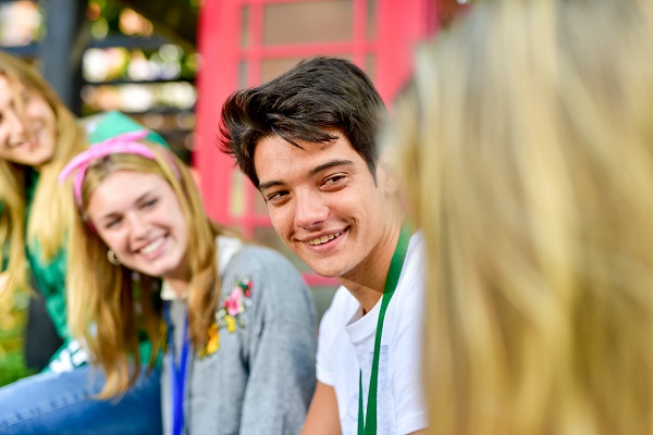 group of teenagers girls and boys in summer sunshine